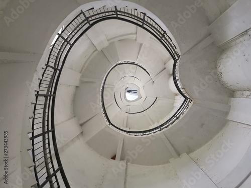 Spiral Staircase Going Up In A Lighthouse With Low Perspective and Reuleaux Triangle Shape - Looking Up At Circular Stairs