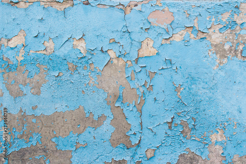 Close-up of peeling painted wall. Old blue peeling paint texture as background