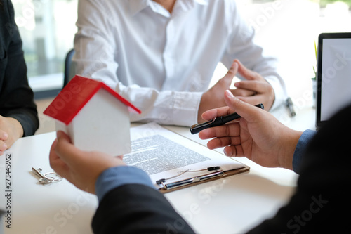 lawyer insurance broker consulting giving legal advice to couple customer about buying renting house. financial advisor with mortgage loan investment contract. realtor selling real estate