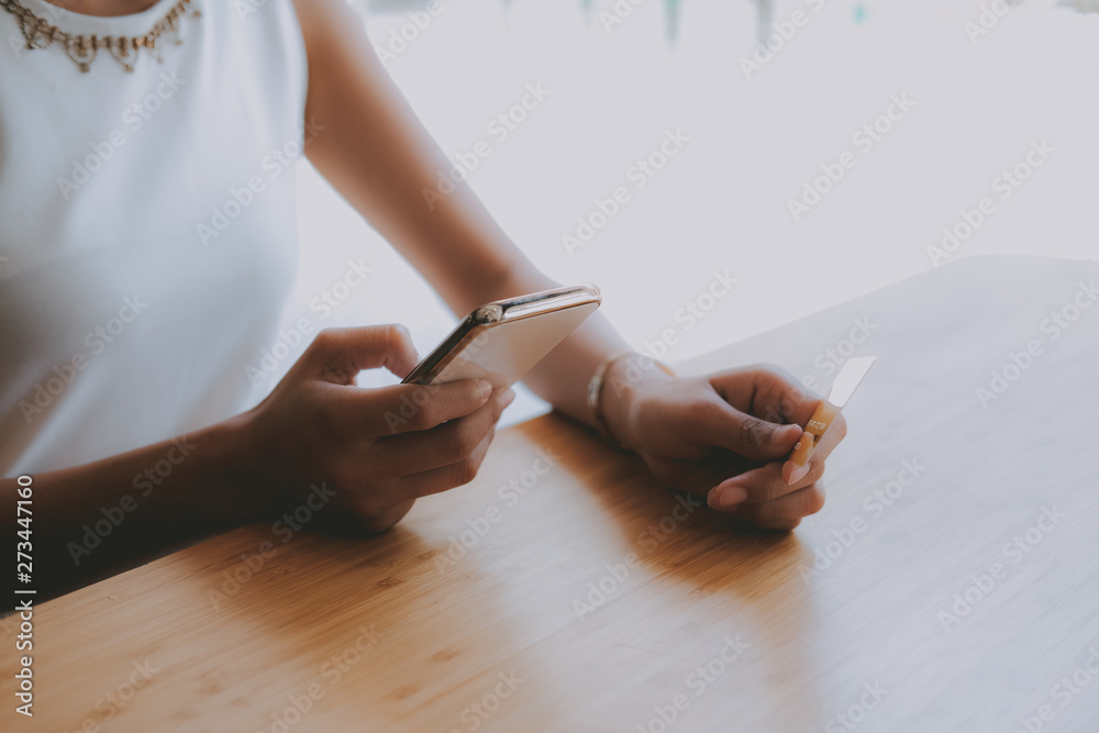 woman holding mobile smart phone & credit card for online shopping