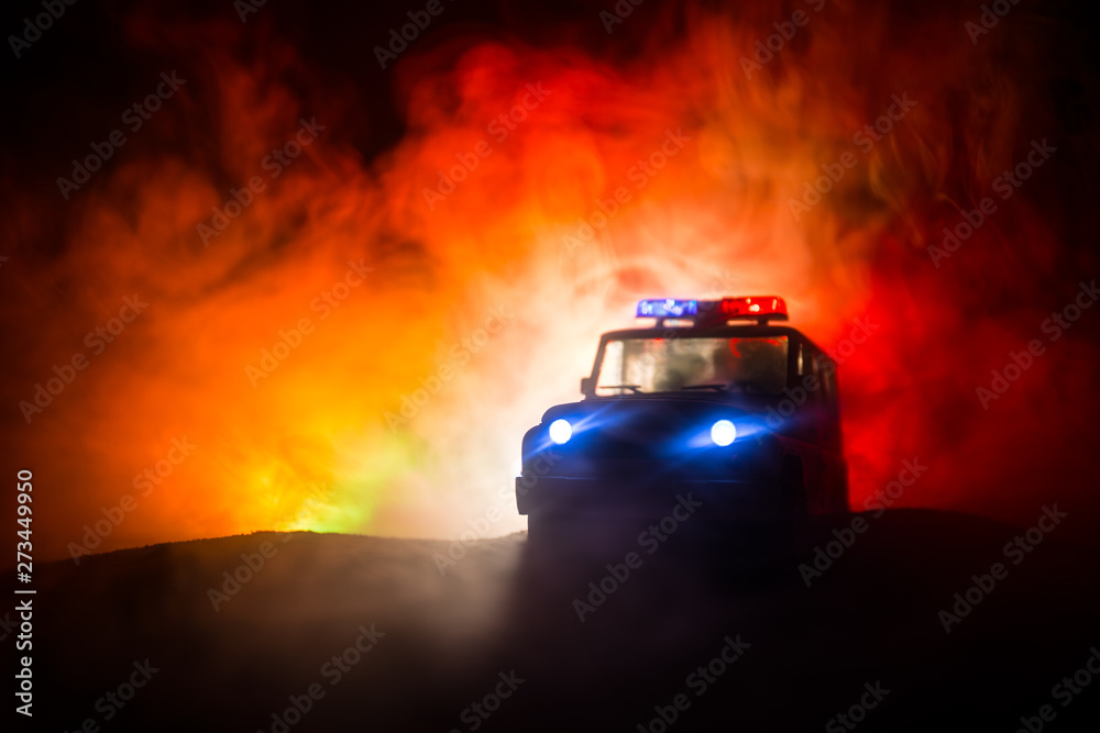 Police cars at night. Police car chasing a car at night with fog background. 911 Emergency response