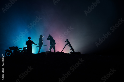 War Concept. Military silhouettes fighting scene on war fog sky background,