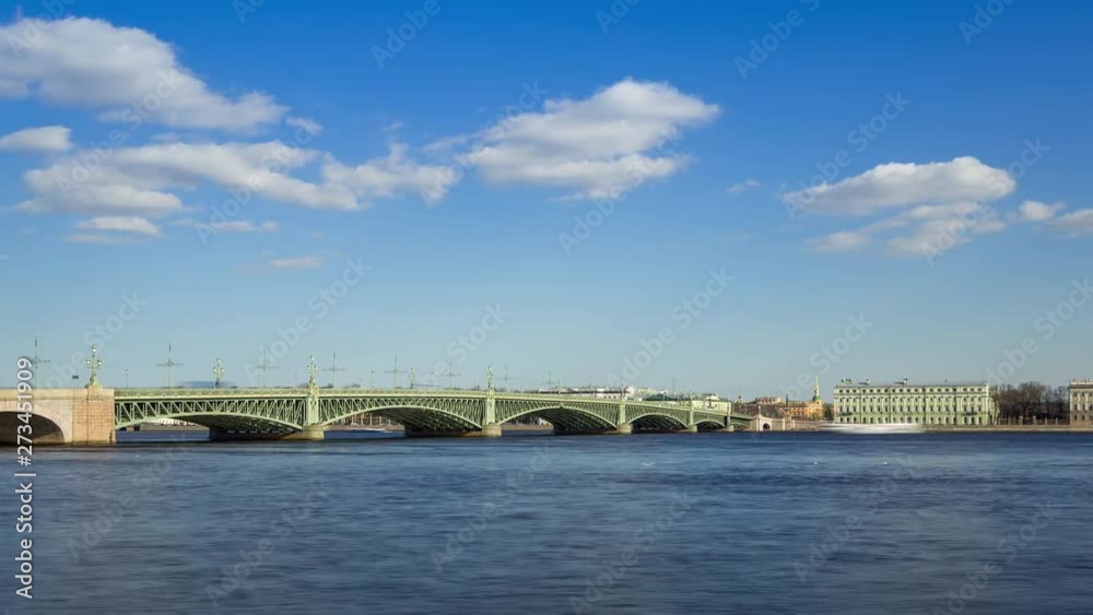 Traffic of cars by Trinity Bridge (Troitskiy Most) over the Neva river and The Palace Embankment (Palace Quay) in sunny day, St. Petersburg, Russia, timelapse Traffic of cars by Trinity Bridge (Troitskiy Most) over the Neva river and The Palace Embankment (Palace Quay) in sunny day, St. Petersburg, Russia, timelapse