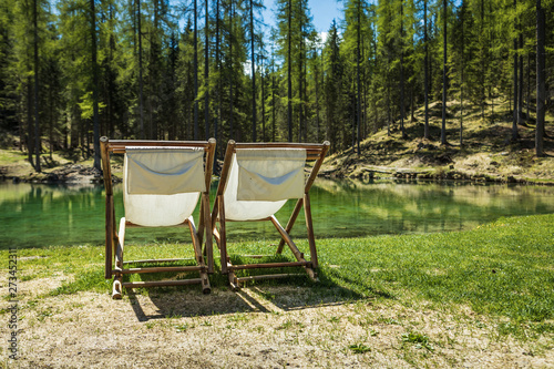 Sun chairs in Lago Ghedina, an alpine lake in Cortina D'Ampezzo, Dolomites, Italy