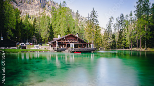 The lodge over the turquoise waters of Lago Ghedina, an alpine lake in Cortina D'Ampezzo, Dolomites, Italy