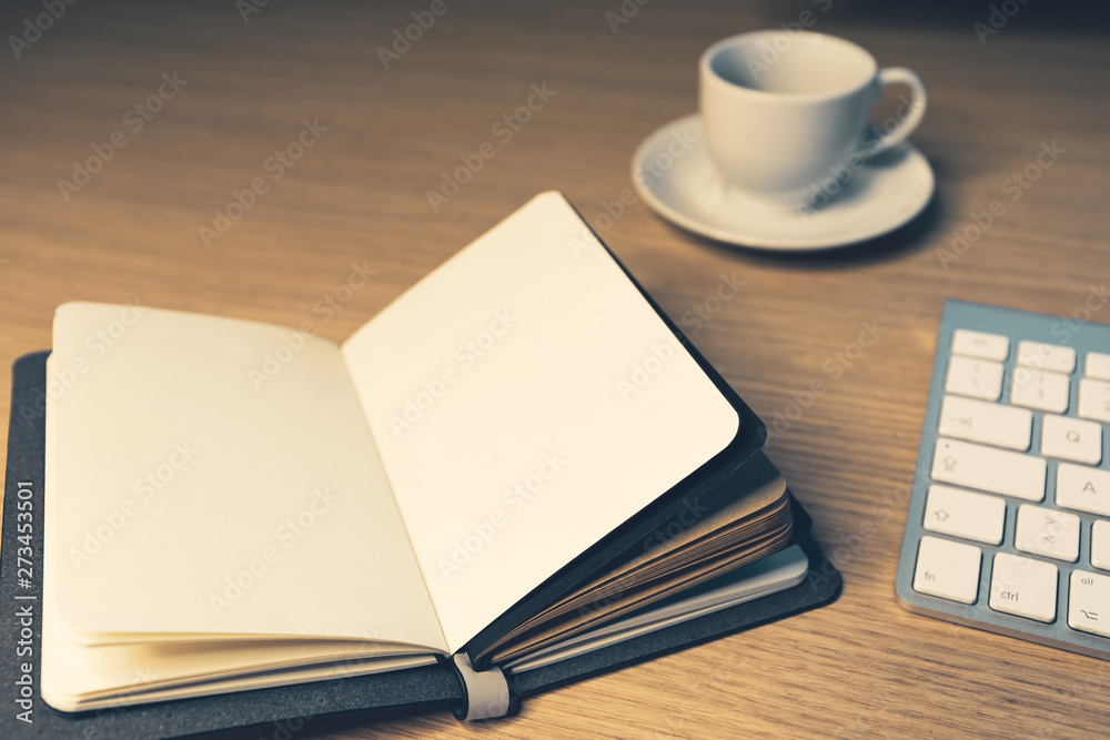 Fototapeta premium Office desk table with notebook and coffee cup