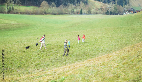 Large family having trekking day in mountains on summer day - Parents and children having fun together in nature with their dog - Healtyh and vacation concept - Focus on mother and father body © DisobeyArt