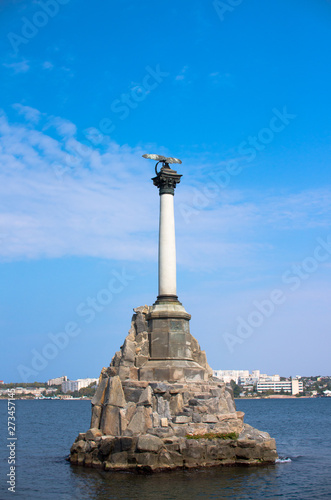 Monument to the flooded ships in Sevastopol on the background of the bay and blue sky.