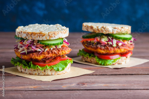 healthy vegetarian burgers with rice diet bread carrot cutlet lettuce coleslaw tomato cucumber on the table