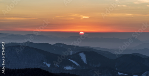 sunset with colorful sky in winter mountains photo