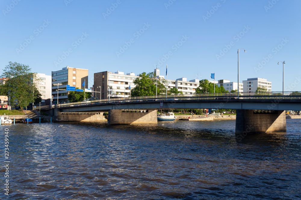 Bridge over the Auroioki River and residential buildings in the city of Turku in Finland on a summer sunny day.