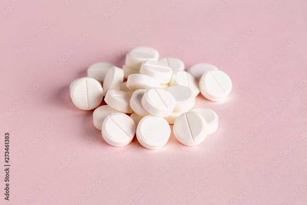 Medicinal round pills on a pink background Medicinal round pills on a pink background