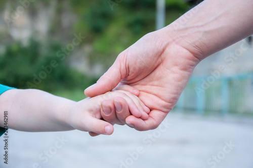 mother holds the hand of a small child. Hand in hand. © amdre100