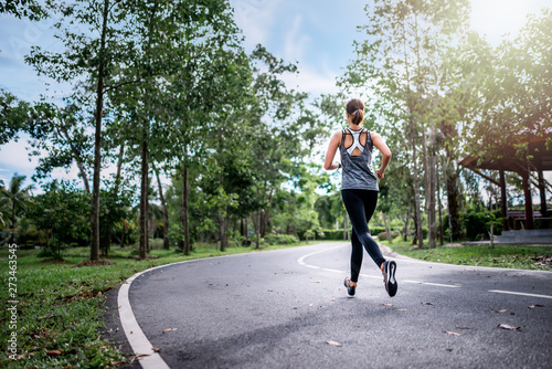 young asian woman runner athlete running at garden