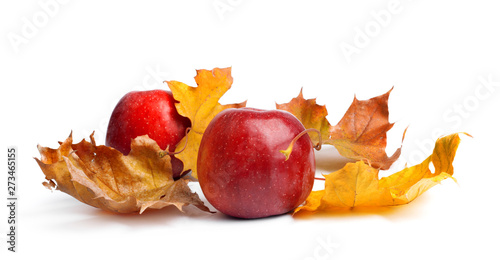 Several ripe juicy red apples with autumn leaves on  isolated background