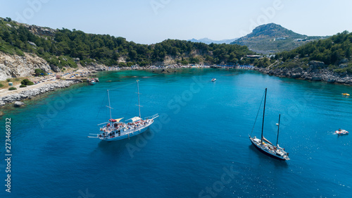 Aerial shot of beautiful blue lagoon at hot summer day with sailing boats and peopleon it. Top view.