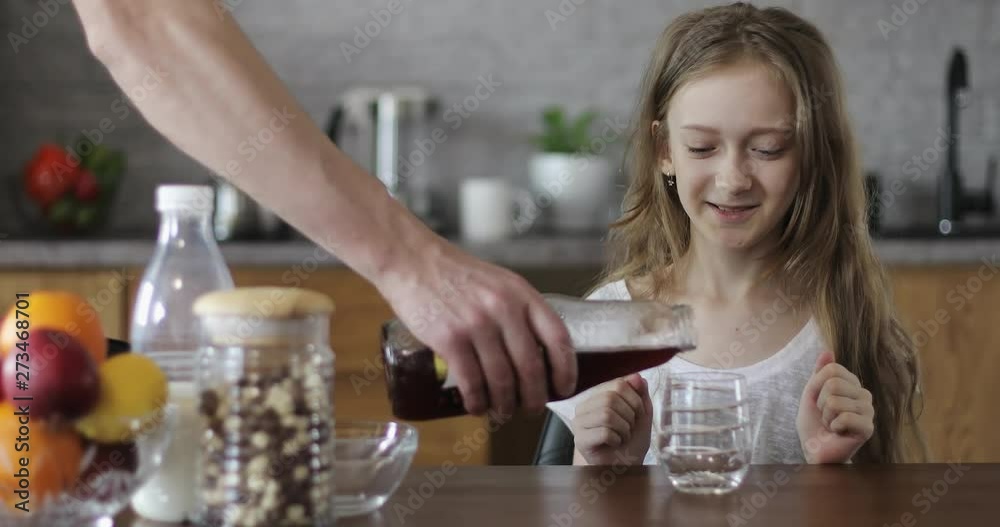 Happy child drinking pomegranate juice in the kitchen. Happy child drinking pomegranate juice in the kitchen.