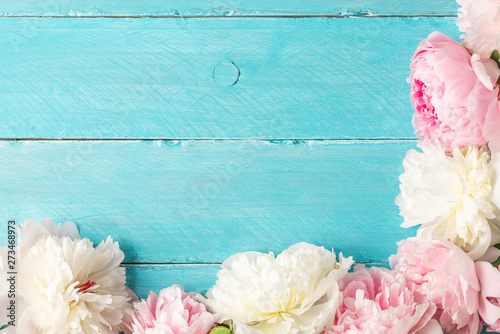 Fototapeta Naklejka Na Ścianę i Meble -  peony flowers on blue wooden table. flat lay. top view