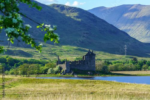 Kilchurn Castle , in the care of Historic Environment Scotland , is a ruined structure on a rocky peninsula at Loch Awe in twilight , Argyll and Bute, Scotland