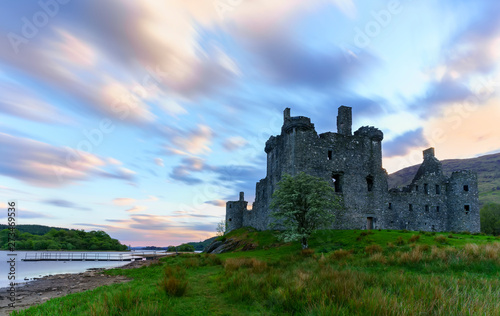 Kilchurn Castle   in the care of Historic Environment Scotland   is a ruined structure on a rocky peninsula at Loch Awe in twilight   Argyll and Bute  Scotland