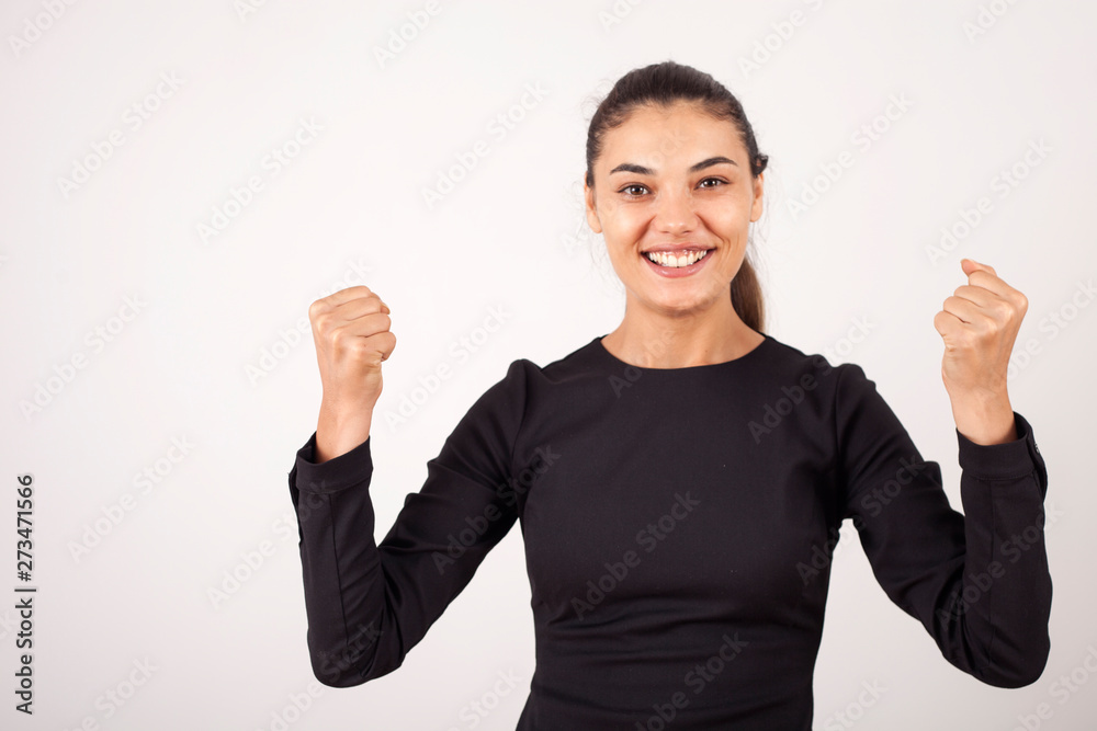 beautiful young businesswoman standing with crossed arms and smiling at camera in office beautiful young businesswoman standing with crossed arms and smiling at camera in office