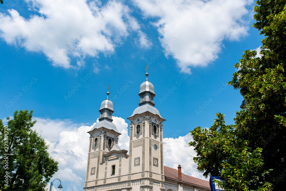 Roman Catholic church , blue sky with white clouds. Roman Catholic church , blue sky with white clouds.