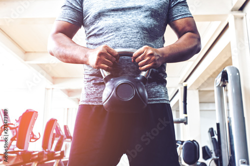 Fényképezés strong young man wearing an athletic sportswear is ready to exert his dumbbells