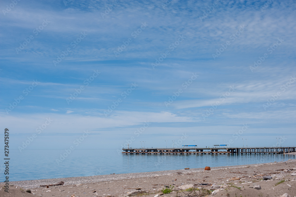 Sea pier, blue sky with light clouds