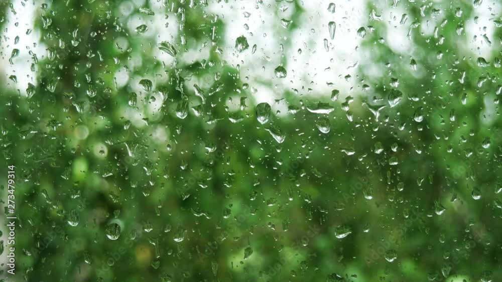 Rain drops running down on of a window glass. Rain drops running down on of a window glass.