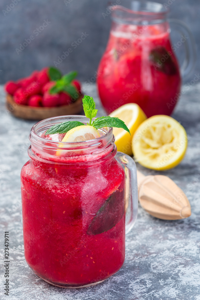 Refreshing raspberry, lemon and mint lemonade with sparkling water in jar, vertical Refreshing raspberry, lemon and mint lemonade with sparkling water in jar, vertical