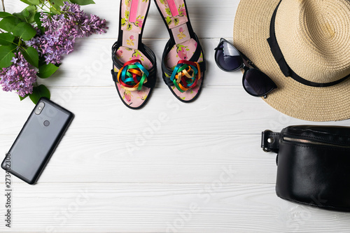 Beauty fashion composition with shoes hat sunglasses cellphone and flowers