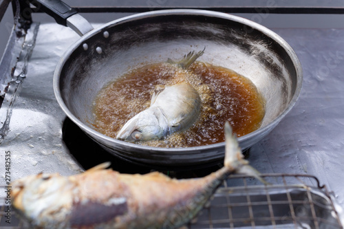 Street vender Deep fried Mackerel fish in hot pan.