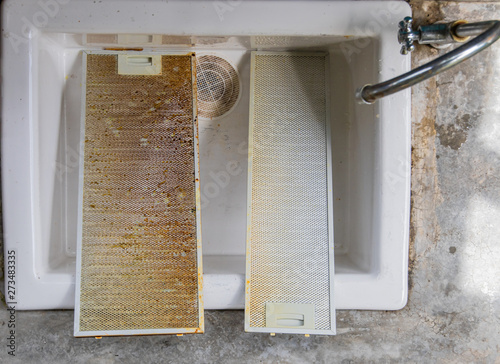 Dirty filter on the kitchen hood in the sink.