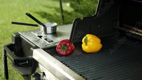 Spread the vegetables on the grill. Grilled bell peppers. Red and yellow bell peppers on a grill grate. Cooking vegetables on the grill