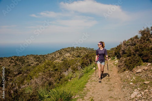 Slika na platnu Woman walking on the path with special sticks