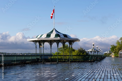 Pretty elegant 1879 backlit gazebos on Dufferin Terrace in the early morning, with the St. Lawrence River and south shore in the background, Quebec City, Quebec, Canada photo