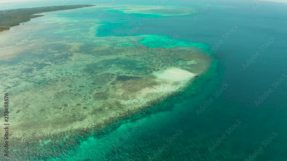 Small sandy beach on a coral atoll in turquoise water, aerial view. Summer and travel vacation concept. Balabac, Palawan, Philippines. Small sandy beach on a coral atoll in turquoise water, aerial view. Summer and travel vacation concept. Balabac, Palawan, Philippines.