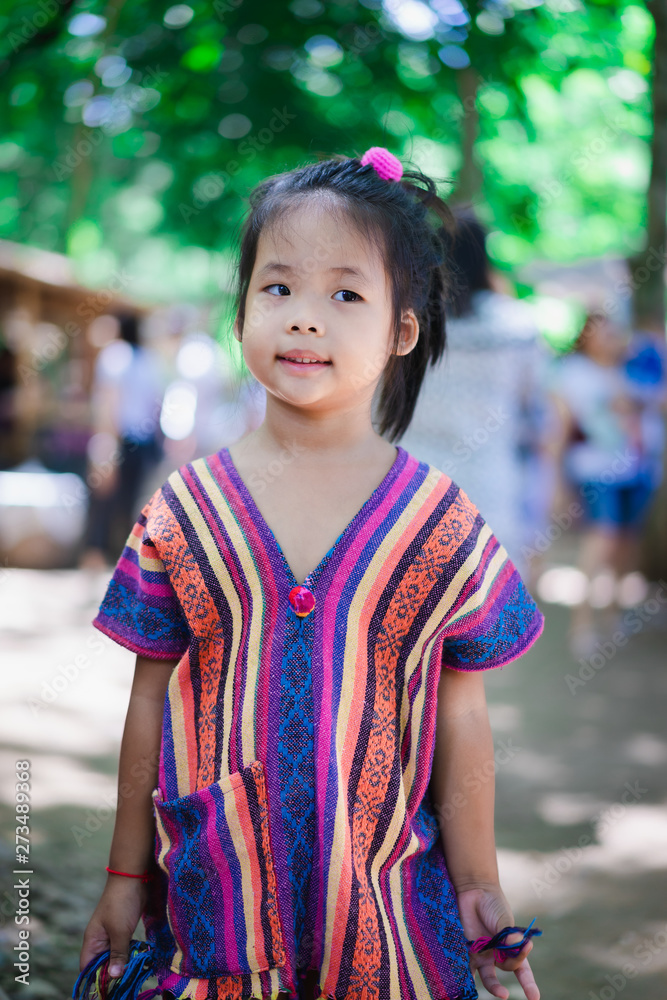 Portrait of happy asian little girl in dress standing in the market Portrait of happy asian little girl in dress standing in the market