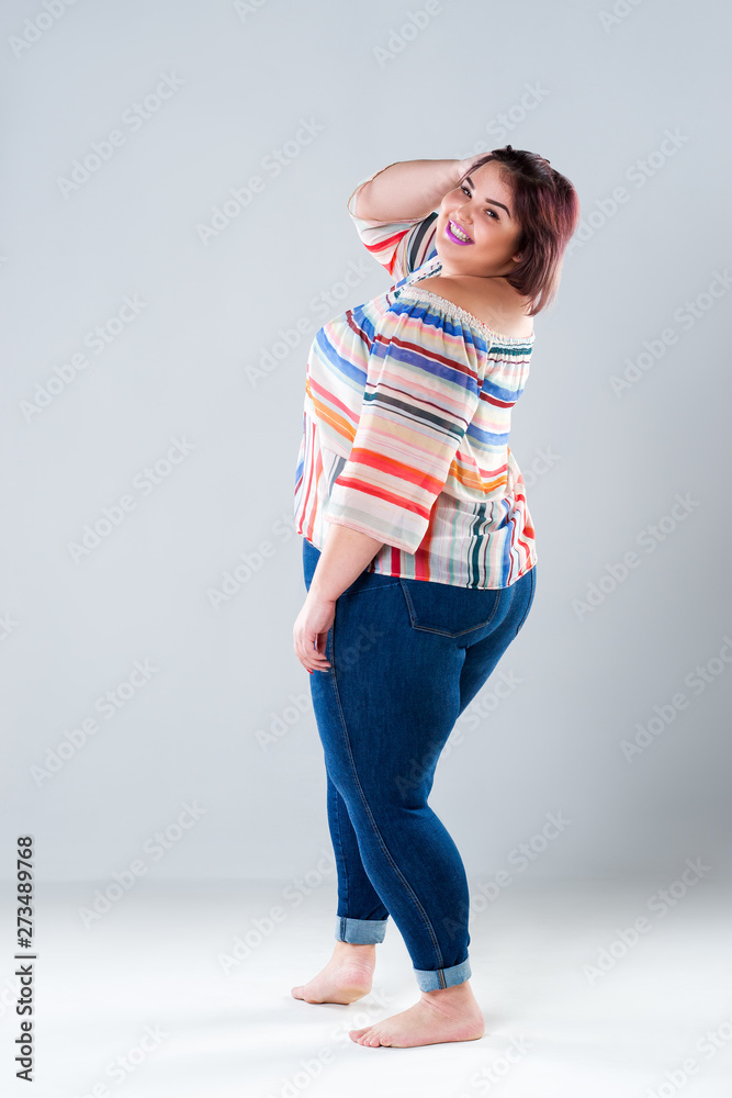 Happy plus size fashion model in casual clothes, fat woman on gray  background, body positive concept Stock Photo | Adobe Stock