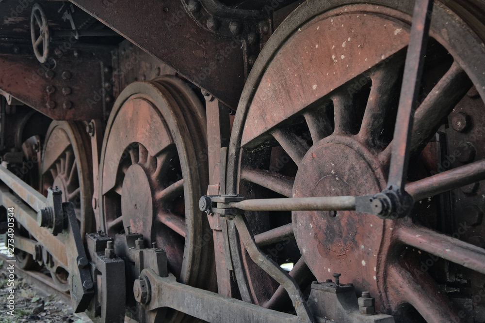 Close-up of the drive wheels and the drive rod of a historic steam locomotive, transport