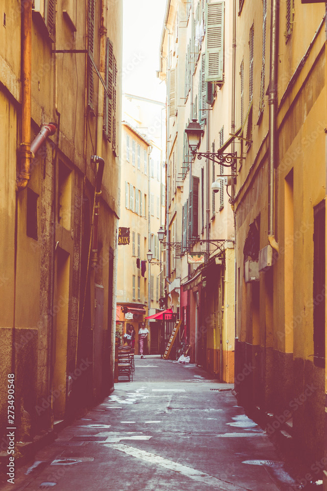 Fototapeta premium NICE, FRANCE - JUNE 05, 2019: Narrow street in old part of Nice, France.