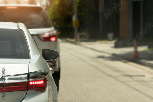 Luxury of silver car stop on the asphalt junction by traffic light control. Traveling in the provinces during the bright period. Open light break. 