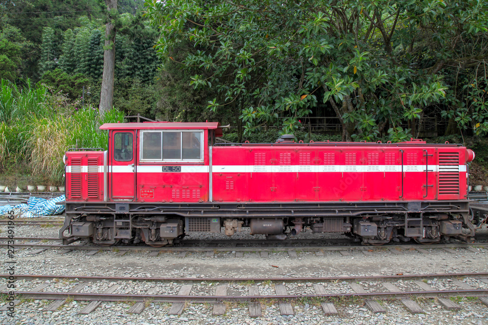 Alishan,taiwan-October 15,2018:The old red Train in Alishan Line (downhill) come back to Chiyi train station at foggy day. Alishan,taiwan-October 15,2018:The old red Train in Alishan Line (downhill) come back to Chiyi train station at foggy day.