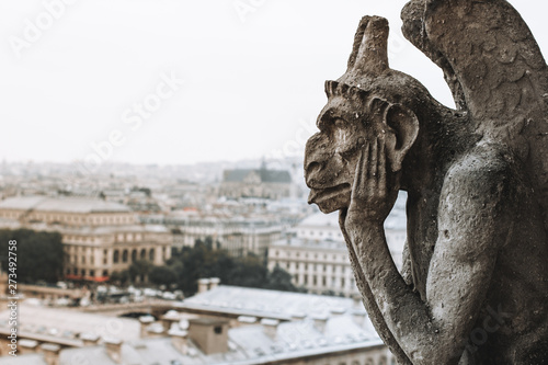 Thinking figure called Chimera or grotesque in Paris France from Bell tower of Basilica of Notre Dame