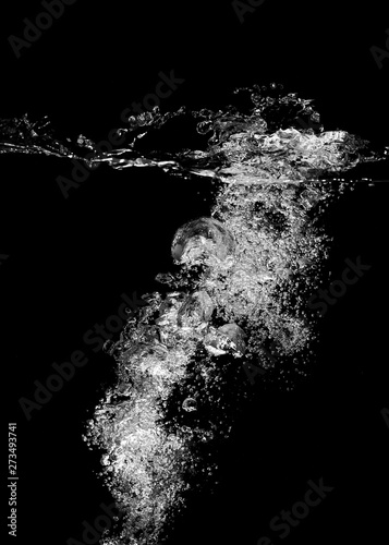 Underwater white bubbles on a black background. © prasong.