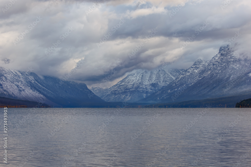 Stormy clouds over rugged mountains and lake in autumn, Glacier Park, Montana Stormy clouds over rugged mountains and lake in autumn, Glacier Park, Montana