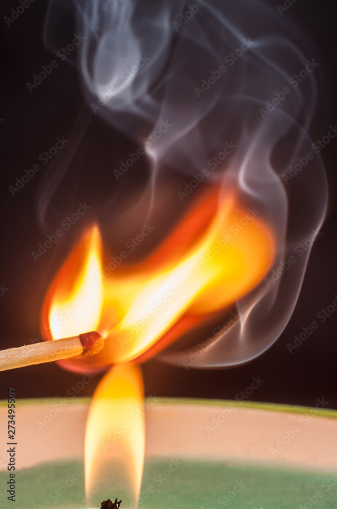 Igniting matches from a candle fire with smoke effectively. Sulfur ignition close up. Macro shooting.