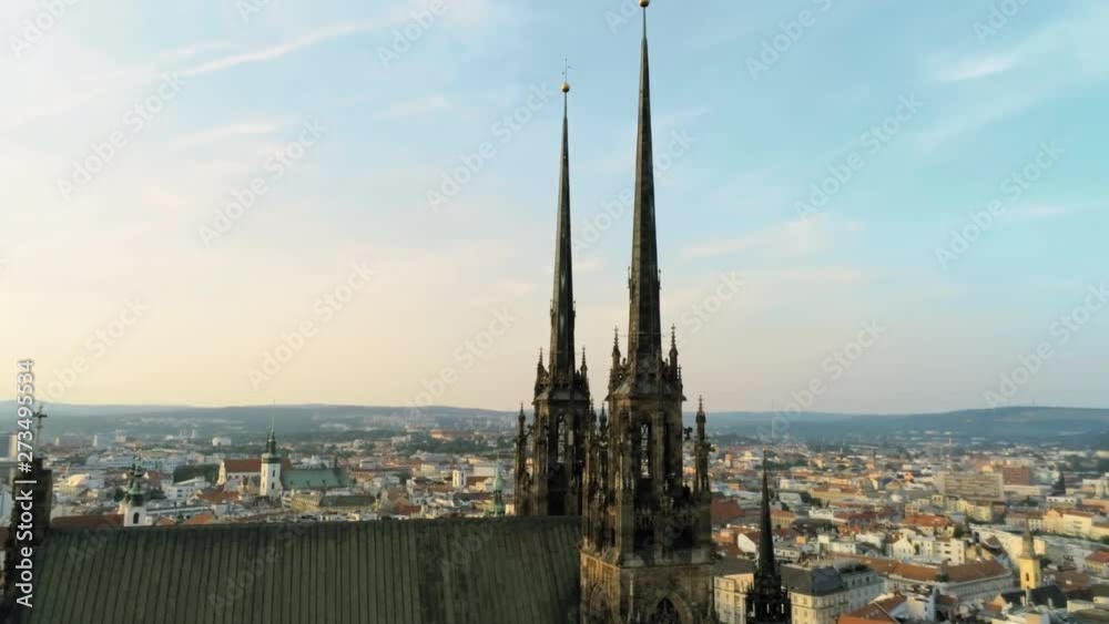 Aerial Zoom Shot of Medieval Gothic Towers of Church on Petrov Hill and Old Town at Sunset. Europe, Czech Republic, Brno, Cathedral of St. Peter And St. Paul. 4K Zoom Drone Shot