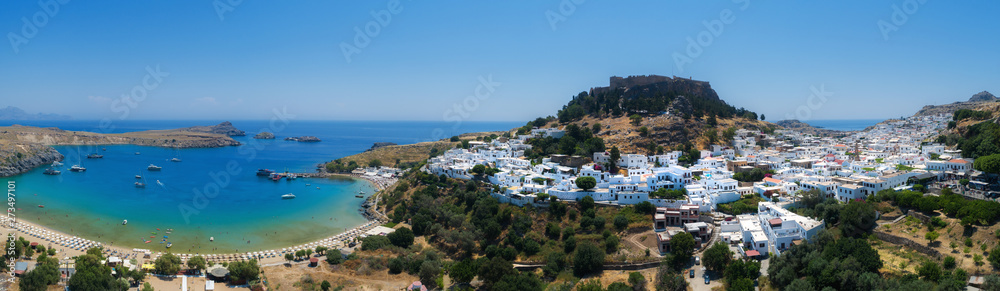 Panorama of the ancient Greek city of Lindos, the island of Rhodes Greece. Traditional white houses, castle and beautiful beach.