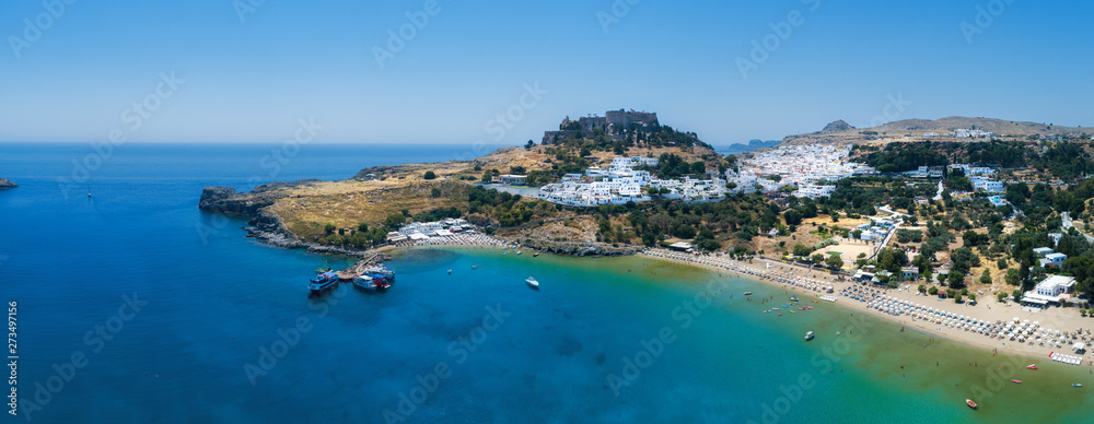  Aerial birds eye view drone photo of village Lindos, Rhodes island, Greece. Beautiful panorama with castle, Mediterranean sea coast. Famous tourist destination in South Europe.